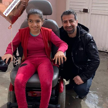 Photos from powered wheelchair distribution events.