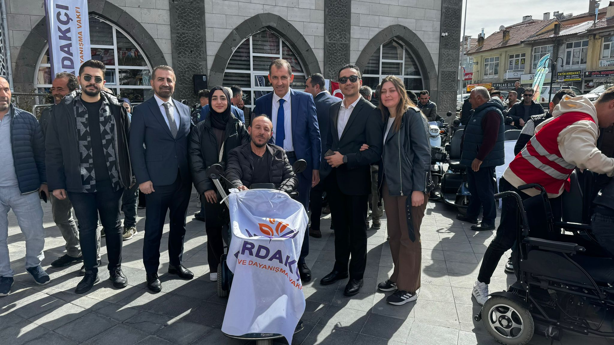 Photos from powered wheelchair distribution events.