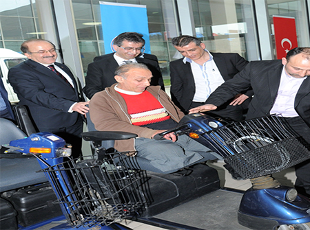 Photos from powered wheelchair distribution events.
