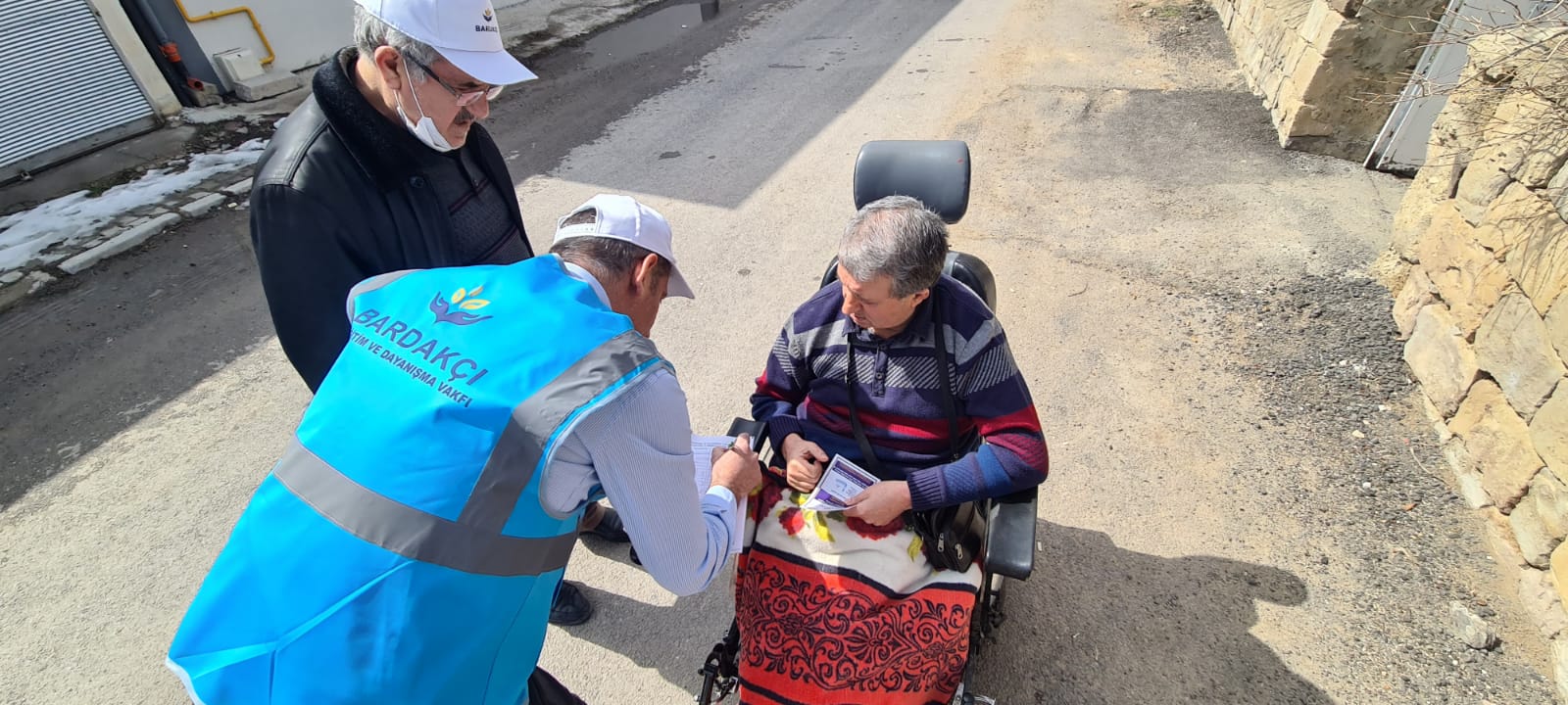 Photos from powered wheelchair distribution events.